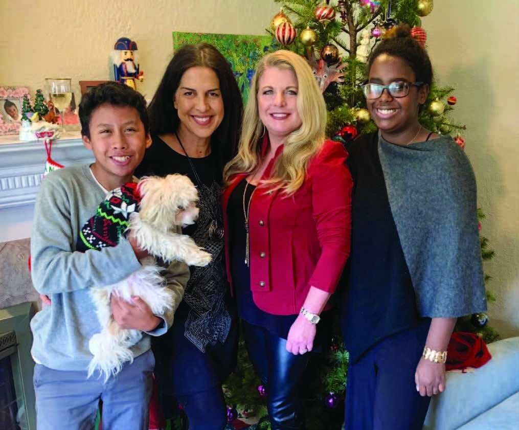 Shirin (second from left), with her son Kian (holding Maggie the Magnificent), fiancé Tracey Mason, and daughter Iman (far right)